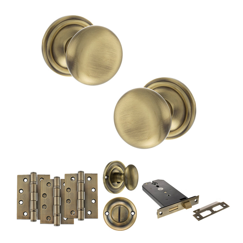 Old English Harrogate Door Knob Pack (Lock Set - Horizontal Bathlock, 4" Fire Rated Hinges x3) - Antique Brass