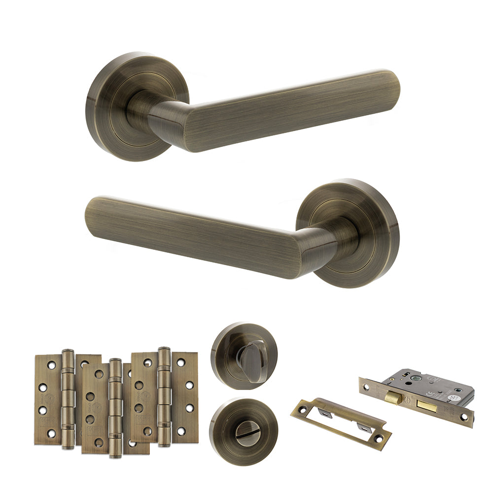 STATUS Carolina Door Handle Pack (Bathroom Set - 3" CE Bathroom Lock, 4" Fire Rated Hinges x3) - Antique Brass